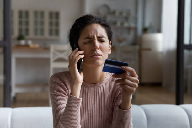 Unhappy woman talking on smartphone with bank client support operator close up, upset depressed young female having problem with credit card or payment, loss money, internet fraud and scam concept